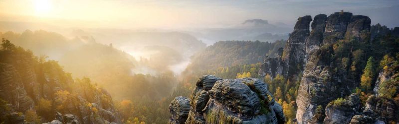 Sun burns up the mist over the Elbe Sandstone Mountains, which straddle the border between the state of Saxony in southeastern Germany and the North Bohemian region of the Czech Republic