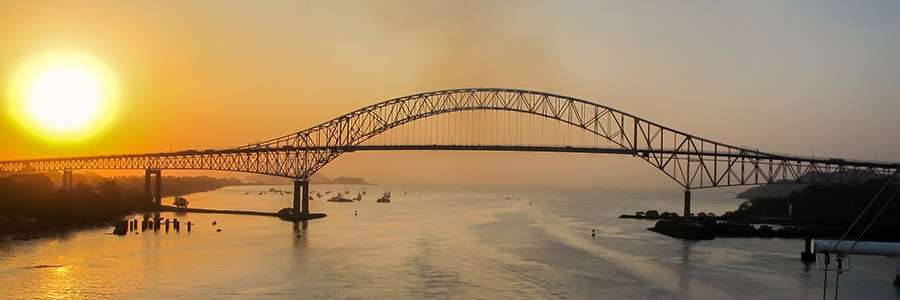 Sun rising over the bridge of the Americas closing the gap between North and South America at the Panama Canal in Panama City, Panama.